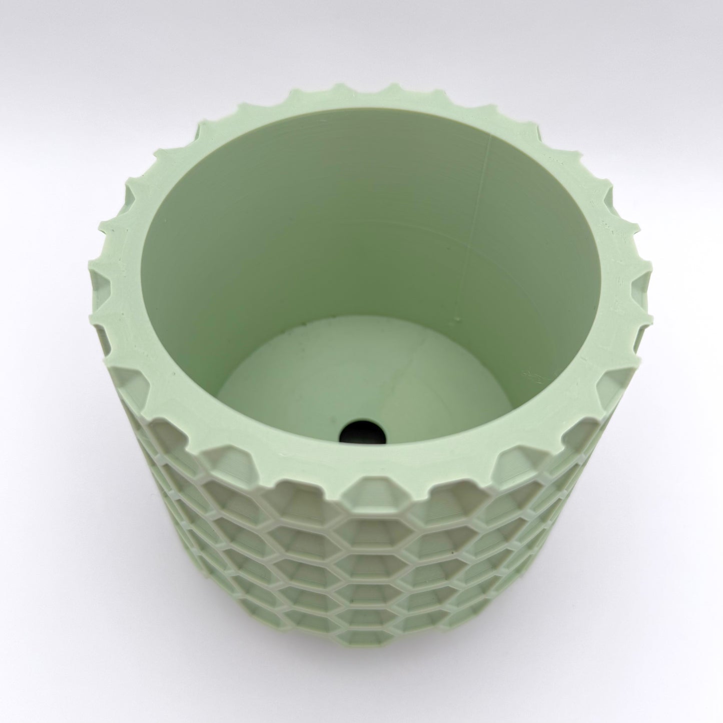Honeycomb 3D printed planter with a geometric honeycomb design and drainage tray. Shown in mint.