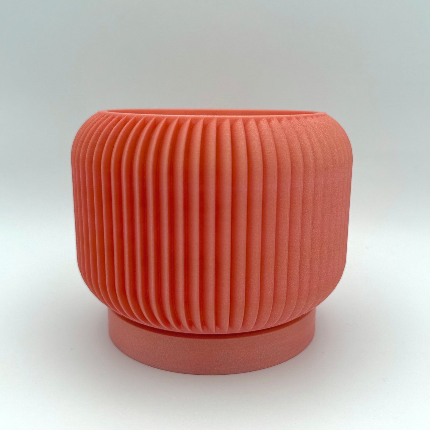 Striation 3D printed planter with drainage tray featuring modern, sleek design for indoor house plants. Shown in rose gold.