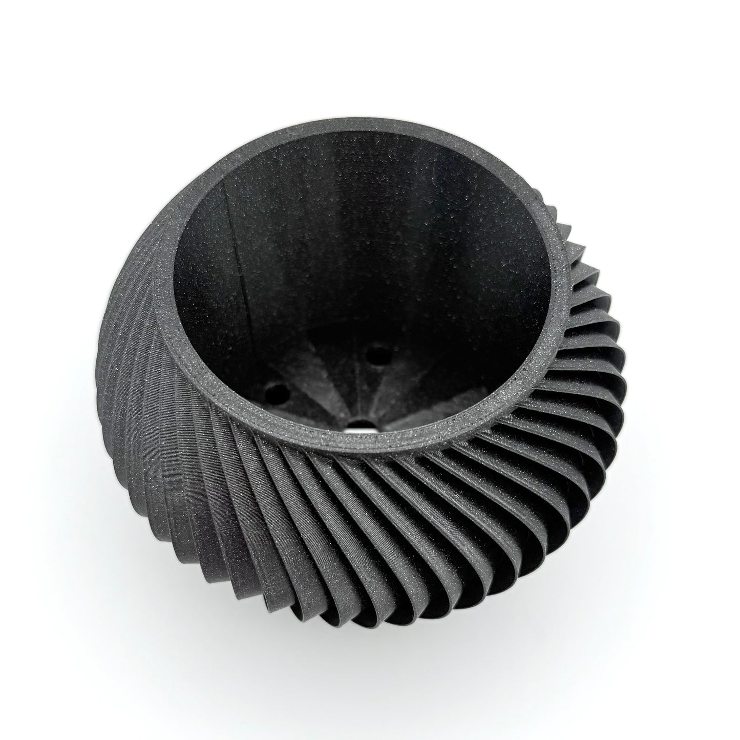 Ridge wave 3D printed planter with a wave pattern design and a drainage tray. Shown in galaxy black.