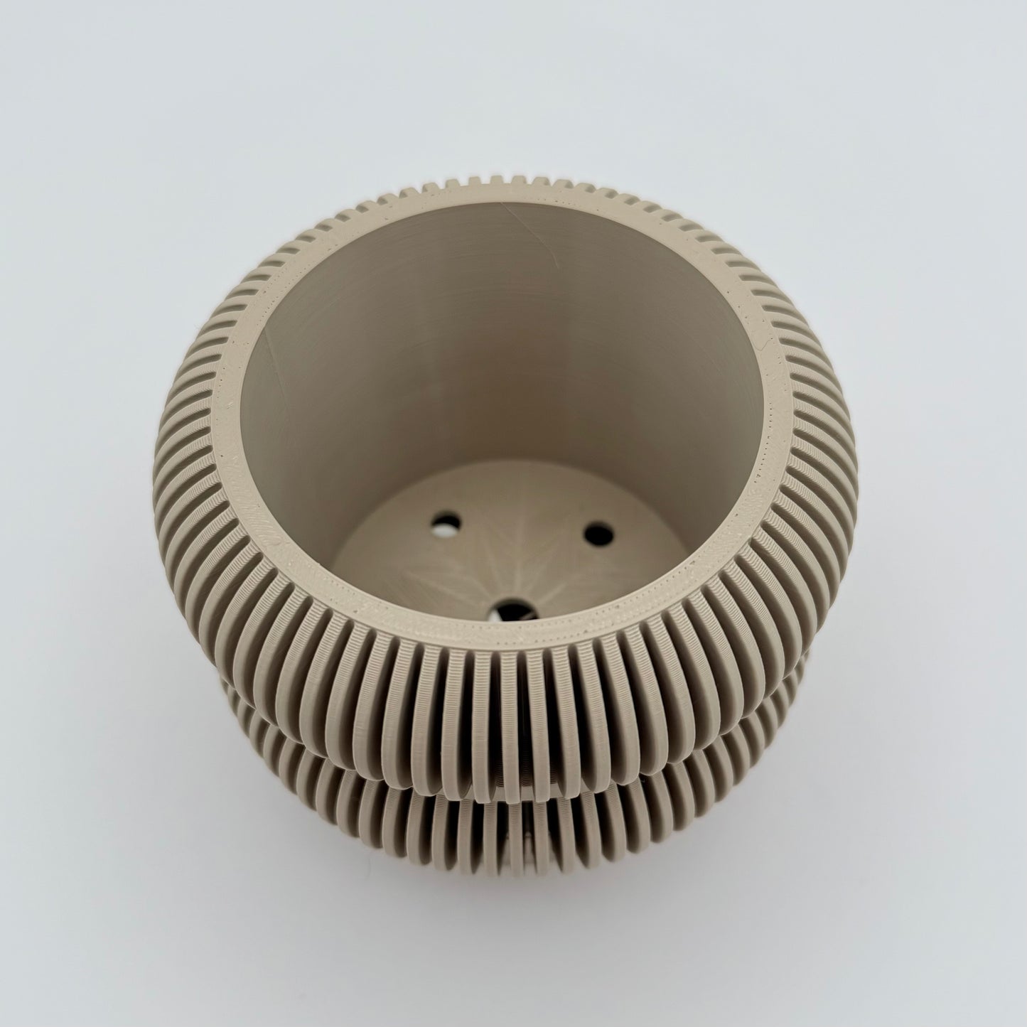 Ridgestack 3D printed planter with drainage tray, featuring a mid-century modern design with thin ridges. Shown in tan.