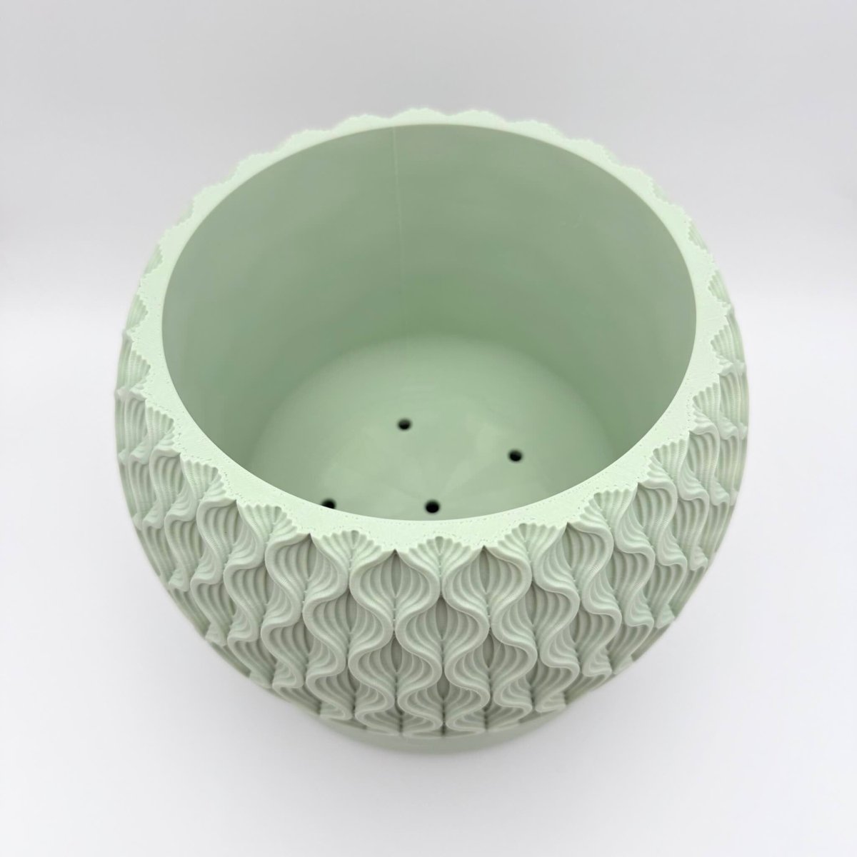 Mint lotus indoor planter pot top down view of drainage holes