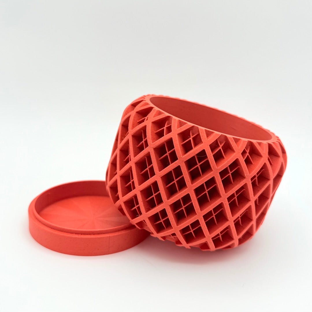 orange geoplaid 3d printed planter tilted on tray